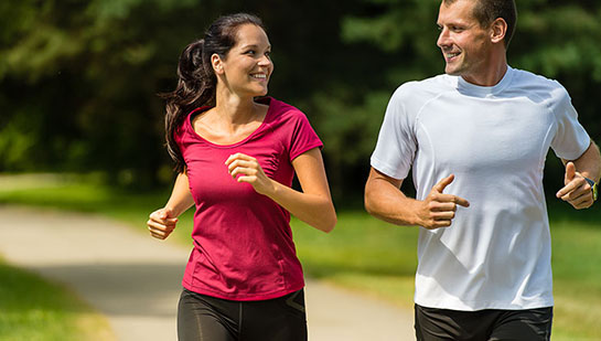 Husband and Wife out on a jog follow health advice from Akron chiropractor