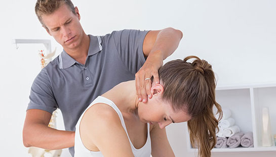 Woman receiving chiropractic adjustment from a Akron chiropractor