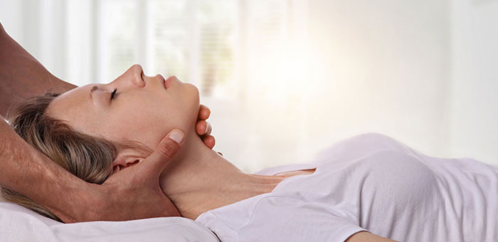 Woman receiving neck adjustment from Akron chiropractor