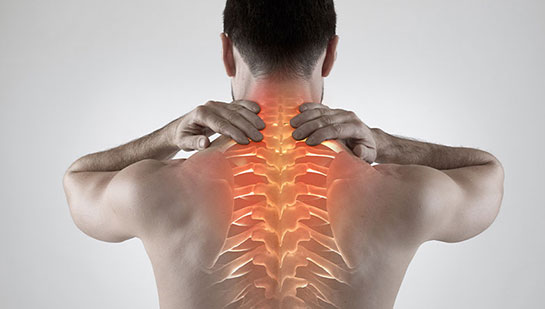 Man with upper back pain before chiropractic treatment from Akron chiropractor